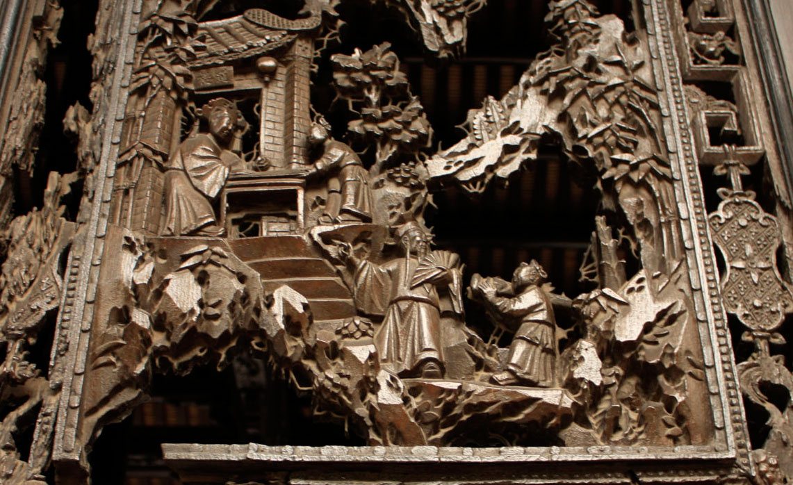 Close view of layered wood carving on a screen door at Chen Clan Ancestral Hall